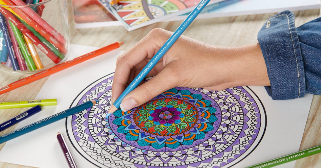 woman coloring mandala with coloring pencils